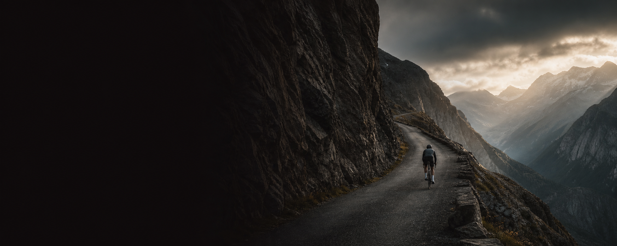 Cyclist climbing a steep alpine road representing the ROCKERON CLIMB World